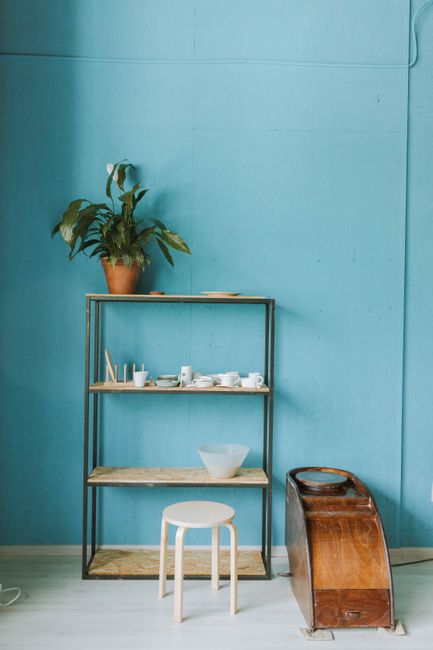 Serene pottery studio interior with wooden shelves