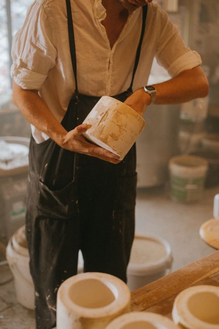 Potter shaping clay on a wheel